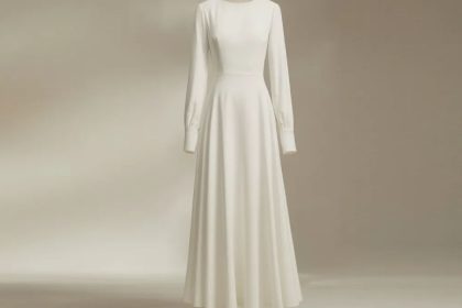 Flowy White Long Sleeve Dress on a model walking by the seaside.